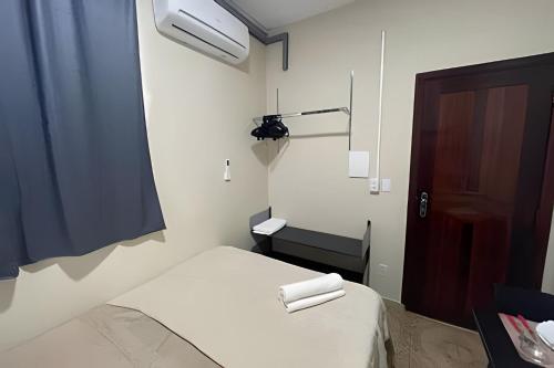 a small room with two beds and a door at Residencial JC II sua casa em Belém do Pará in Belém