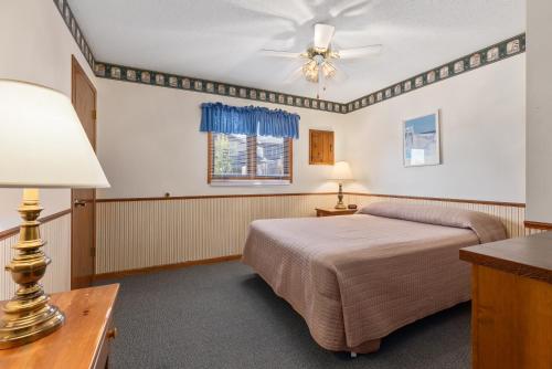 a bedroom with two beds and a ceiling fan at The Lodges at Breezy Point in Breezy Point