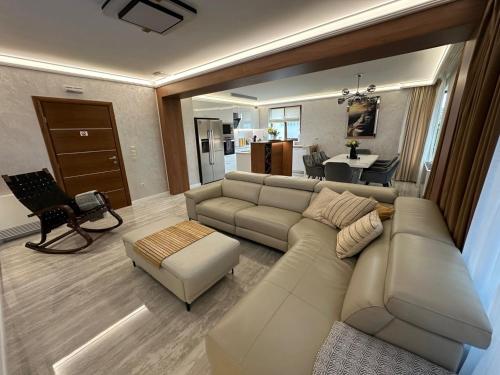 a living room with a couch and a table at Guest House Doni in Sandanski