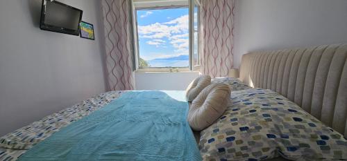 una camera da letto con un letto e una finestra di Apartman Ana Maris a Fiume (Rijeka)