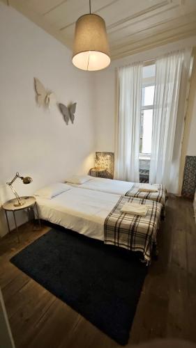 a bedroom with a large bed and a large window at Family downtown apartment - Se21 in Lisbon