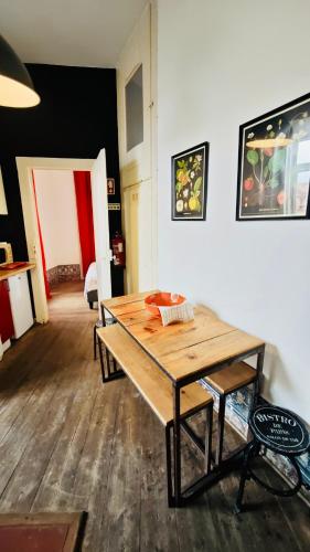 a wooden table sitting in a room with a room at Family downtown apartment - Se21 in Lisbon