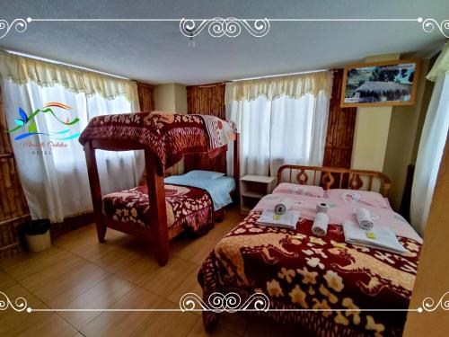 a bedroom with two beds and a canopy bed at Miravalle Quilotoa Hotel in Zumbahua