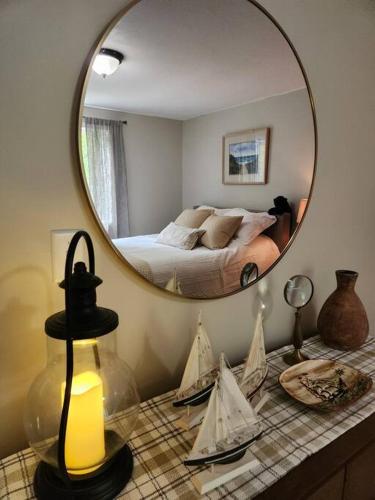 a mirror on a counter in a room with a bed at NEW! Peaceful Retreat at Nary Hill in Wolfeboro