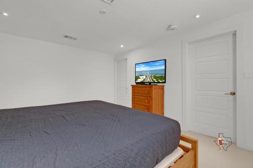 a bedroom with a bed and a flat screen tv at Bahia Mar Solare Beachfront Resort Condos with Two Pools in South Padre Island