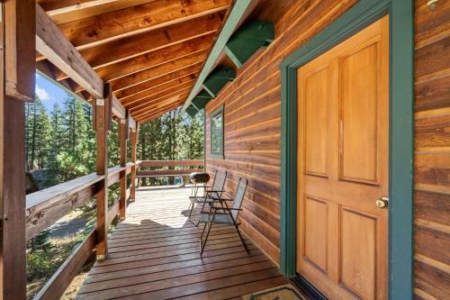 a wooden porch with a door and chairs on it at Mountain Getaway with Granny Unit, Dogs Ok #47 in Bear Valley