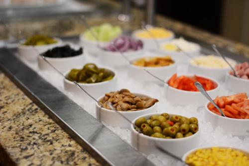 a buffet line with different types of vegetables in bowls at Staybridge Suites Chihuahua by IHG in Chihuahua