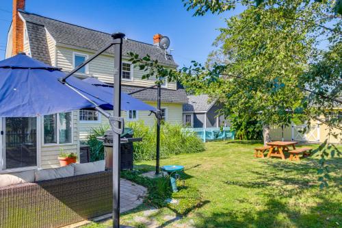 a backyard with an umbrella and a picnic table at Tilghman Island Retreat By Knapps Narrows! in Tilghman