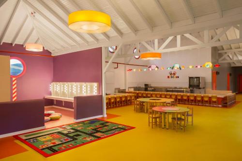 a room with tables and chairs and a dining room at IC Hotels Santai Family Resort - Kids Concept in Belek