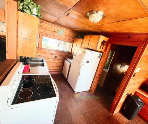 a kitchen with a stove and a white refrigerator at Splash Landing-Long Lake-Traverse City in Traverse City