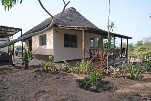 a small house with a thatched roof at Exceptional house with sea view in Cap Skirring in Boukot Ouolof