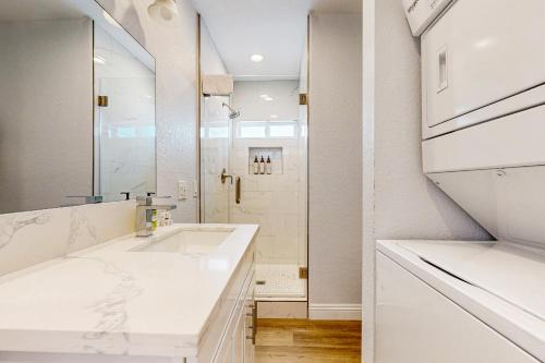 a white bathroom with a sink and a shower at Sunshine Fun Time in Newport Beach