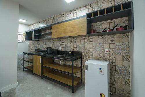 a kitchen with a counter with a sink in it at LOFTS GREEN ISLAND in Abraão