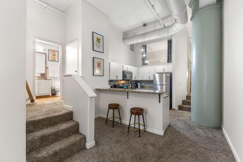 a kitchen with a counter and some stools at 2BR Downtown Gem - Sleeps 7 - Convention Center in Indianapolis