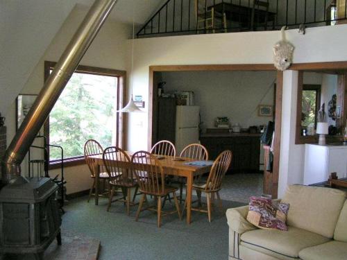 una cucina e una sala da pranzo con tavolo e sedie di Northern Lights-Lake Michigan a Northport