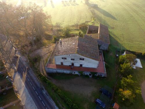 an aerial view of a large white house in a field at Turismo Rural Can Massot in Darnius