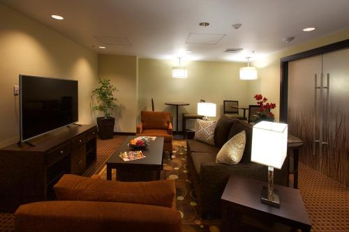 a living room with a couch and a flat screen tv at Staybridge Suites Chihuahua by IHG in Chihuahua
