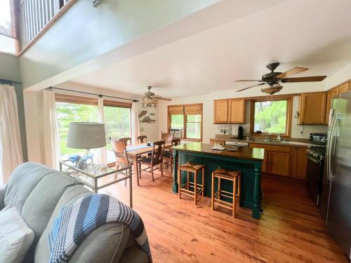 a kitchen and living room with a couch and a table at Peek of the Bay in Suttons Bay