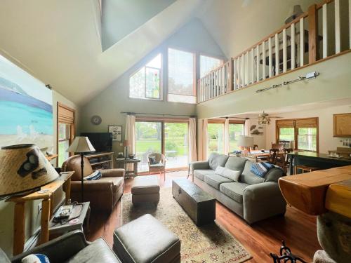 a living room filled with furniture and a large window at Peek of the Bay in Suttons Bay