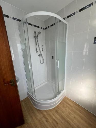 a shower with a glass door in a bathroom at Ullswater Hotel in Bournemouth