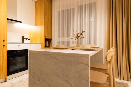 a kitchen with a large marble island in a room at Copal Residence in Baia Mare