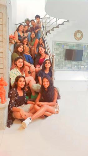 a group of women sitting on the stairs at La Bay Luxury Beach Bungalow in Puducherry