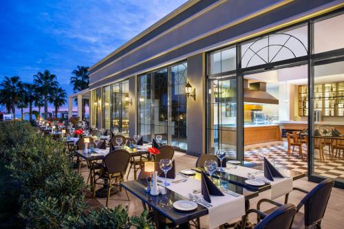 an outdoor dining area with tables and chairs at IC Hotels Santai Family Resort - Kids Concept in Belek