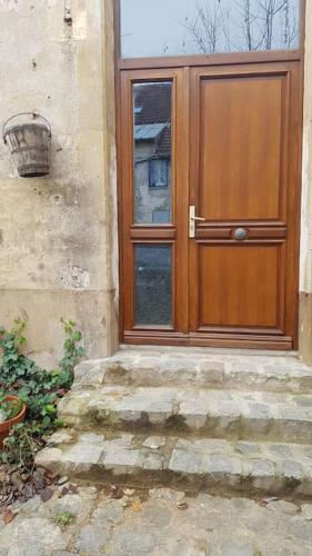 a wooden door on the side of a building at Loft LINAS in Linas