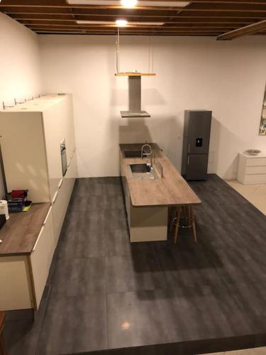 a kitchen with a sink and a refrigerator at Loft LINAS in Linas