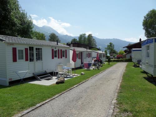 a group of mobile homes parked on the side of a road at Altogold Swiss Holidays At Manor Farm 5* in Interlaken