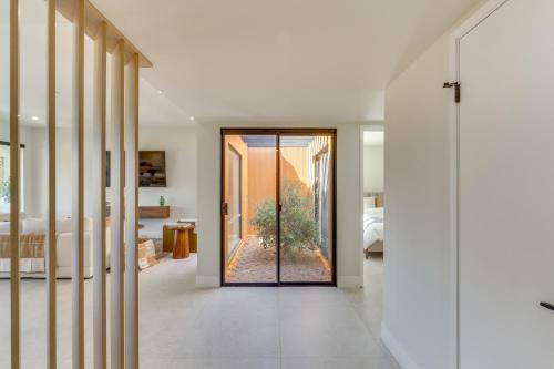 a hallway with a door leading to a bedroom at Rancho Mirage Condo Near El Paseo and The River! in Rancho Mirage