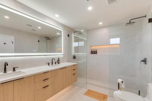 a bathroom with a toilet and a sink and a shower at Rancho Mirage Condo Near El Paseo and The River! in Rancho Mirage