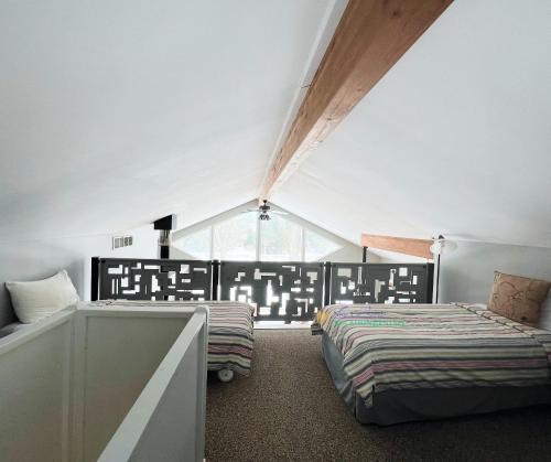 a bedroom with two beds and a large window at All Points North in Beulah