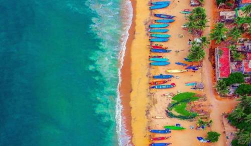 an overhead view of a beach with umbrellas and the ocean at La Bay Luxury Beach Bungalow in Puducherry