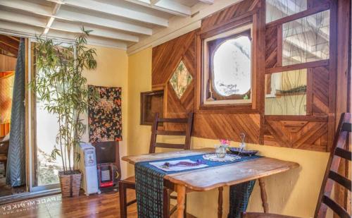 a room with a wooden table and a window at Topanga Wonderland Cottage in Topanga