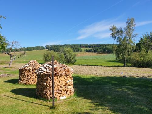 a stack of firebreaks sitting in a field at CHALUPA V PANSKÝM , Staré Křečany u Rumburku in Panský