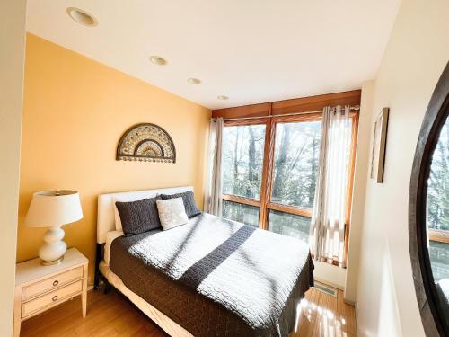a bedroom with a bed and a window at Northern Comfort 2--Long Lake-Traverse City in Traverse City