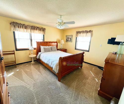a bedroom with a bed and a ceiling fan at Cherry Blossom Farm in Suttons Bay