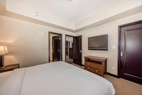 a hotel room with a bed and a television at Copper Point Resort in Invermere