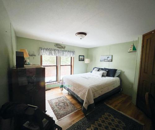 a bedroom with a bed and a window at Bass Lake Pointe in Traverse City