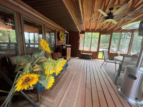 a living room with a couch with sunflowers on it at Bass Lake Pointe in Traverse City