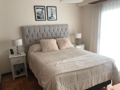 a bedroom with a large bed with two night stands at Arena1 in Mar del Plata