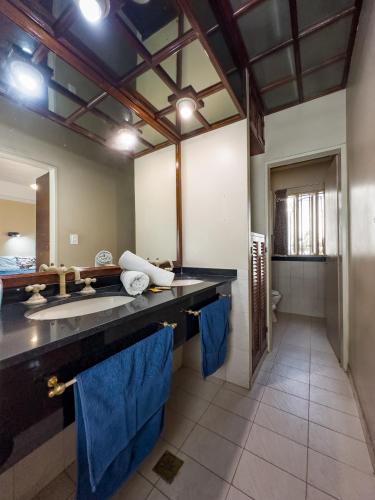 a bathroom with a large sink and blue towels at Rodex Hostel Tucuman in San Miguel de Tucumán