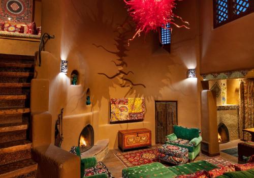 a living room with a couch and a chandelier at The Inn of Five Graces in Santa Fe