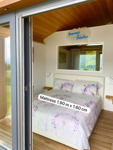 a room with a bed with a mirror on it at Grandin Holidayhouse in Domaso
