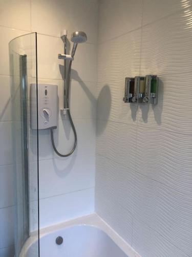 a shower in a bathroom with a glass shower stall at Modern and comfortable stay in Morecambe in Morecambe