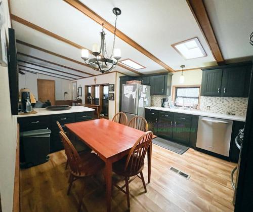 a kitchen with a wooden table and chairs in it at Bass Lake Pointe in Traverse City