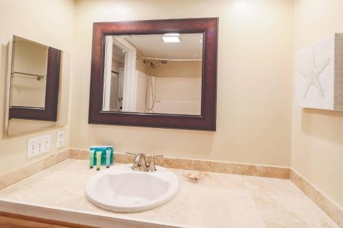a bathroom with a sink and a mirror at Ketch Studio in Hilton Head Island