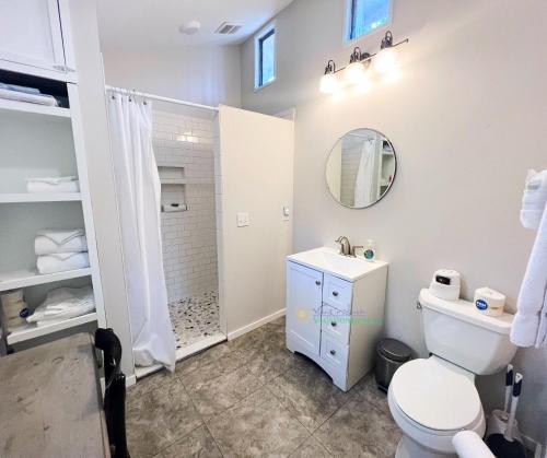a bathroom with a white toilet and a shower at Shoreline Pines in Suttons Bay
