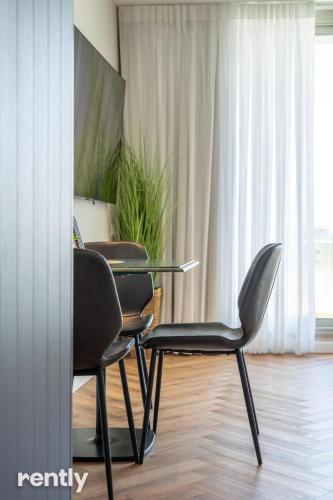 a meeting room with two chairs and a glass table at Luxury Apartments And Studios At Sea Side By Rently in Eilat